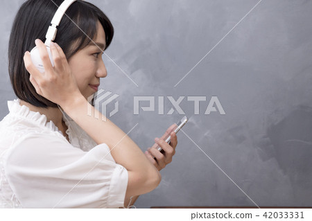 Girl listening to music Girl listening to music 42033331