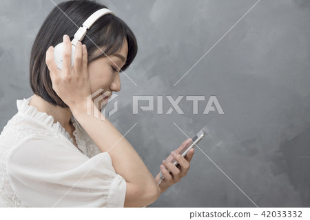 Girl listening to music Girl listening to music 42033332