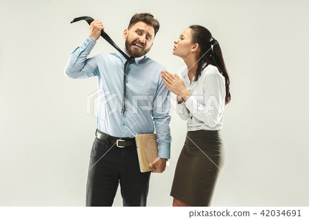 Angry boss. Man and his secretary standing at office or studio Angry boss. Man and his secretary standing at office or studio 42034691