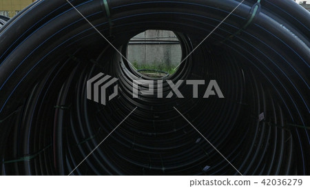 Warehouse of finished plastic pipes industrial outdoors storage site. Manufacture of plastic water Warehouse of finished plastic pipes industrial outdoors storage site. Manufacture of plastic water 42036279