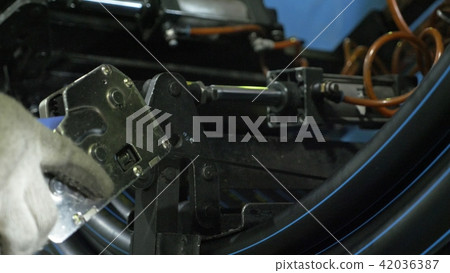 Roll threading coil pipe. Manufacture of plastic water pipes factory. Process of making plastic Roll threading coil pipe. Manufacture of plastic water pipes factory. Process of making plastic 42036387