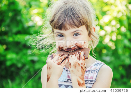 A child eats chocolate. Selective focus. 42039726