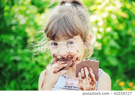 A child eats chocolate. Selective focus. 42039727