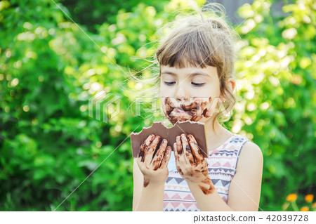 A child eats chocolate. Selective focus. A child eats chocolate. Selective focus. 42039728
