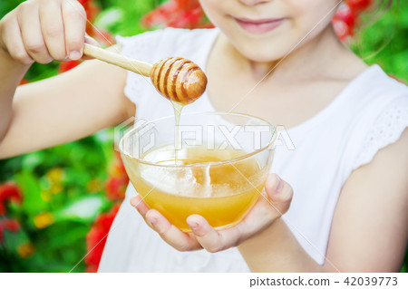 The child eats honey. Selective focus. nature. The child eats honey. Selective focus. nature. 42039773