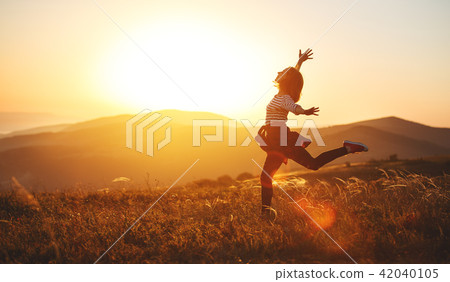 Happy woman jumping and enjoying life at sunset in mountains. Happy woman jumping and enjoying life at sunset in mountains. 42040105