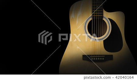 Part of acoustic guitar on old black background Part of acoustic guitar on old black background 42040164