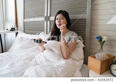 female holding a tissue paper to wipe up tears female holding a tissue paper to wipe up tears 42042972