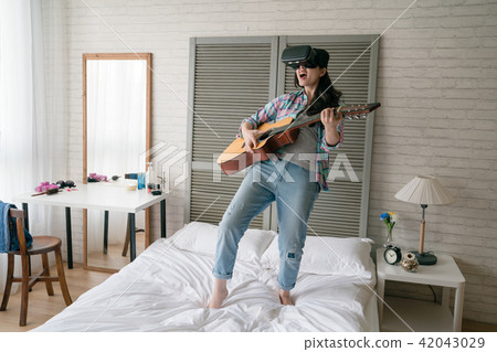 woman lean her body back and hold her guitar woman lean her body back and hold her guitar 42043029