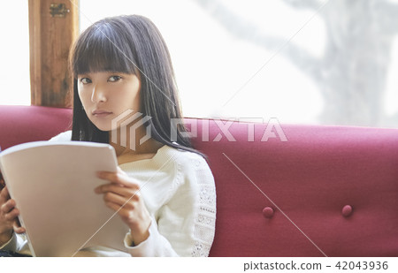 A woman relaxing at a cafe A woman relaxing at a cafe 42043936