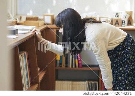 A woman in a book store A woman in a book store 42044221