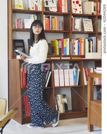 A woman in a book store A woman in a book store 42044269