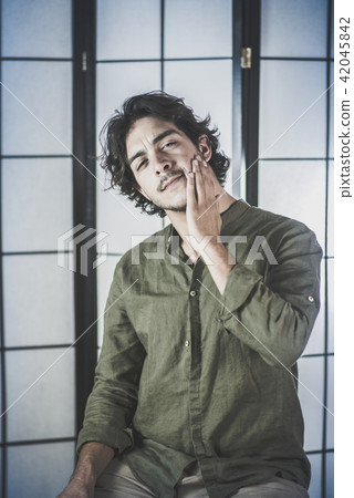Portrait of Young Man With Raised Hands at Chest Portrait of Young Man With Raised Hands at Chest 42045842