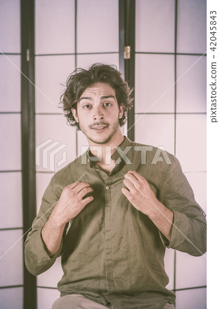 Portrait of Young Man With Raised Hands at Chest Portrait of Young Man With Raised Hands at Chest 42045843
