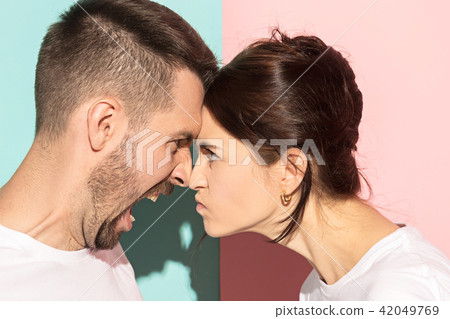 attractive angry couple fighting and shouting at each other attractive angry couple fighting and shouting at each other 42049769