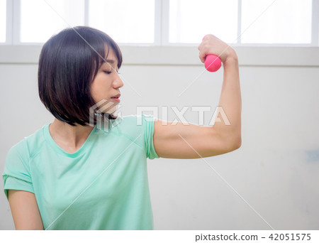 young girl lifting dumbbells young girl lifting dumbbells 42051575