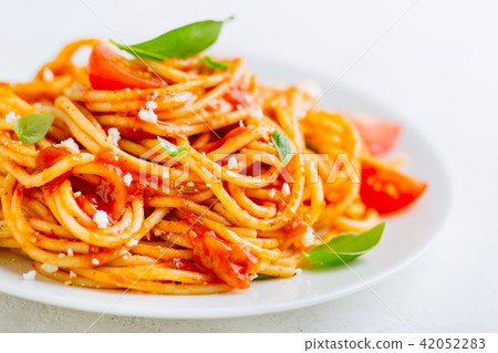 Pasta dish with tomato sauce on white plate 42052283