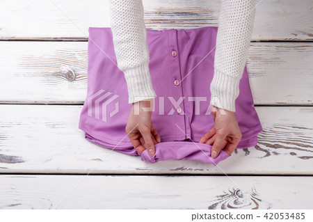 Female hands and purple violete shirt. 42053485