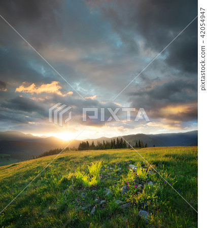 Sunset in the mountain valley. Sunset in the mountain valley. 42054947