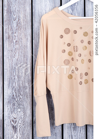 Beige women's blouse sleeve, top view. Beige women's blouse sleeve, top view. 42056356