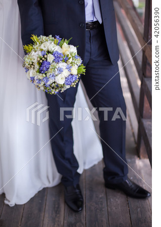 The groom holds wedding bouquet 42056390
