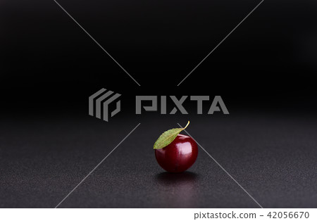 Ripe sweet cherry with leaf isolated on black Ripe sweet cherry with leaf isolated on black 42056670