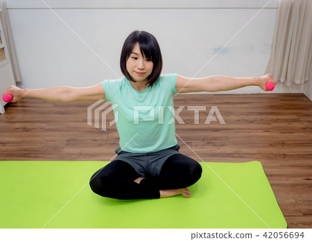 Young girl lifting dumbbells Young girl lifting dumbbells 42056694