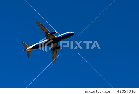 Passenger plane flying in the blue sky 42057016