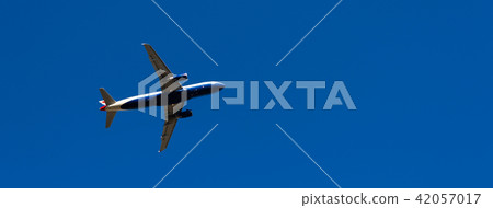 Passenger plane flying in the blue sky 42057017