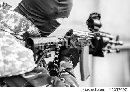 man aiming with an AK-47 man aiming with an AK-47 42057097