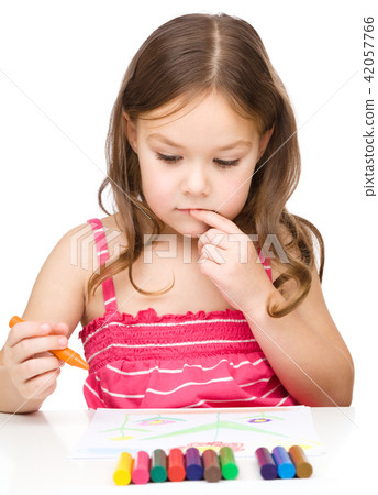 Little girl is drawing using colorful crayons 42057766