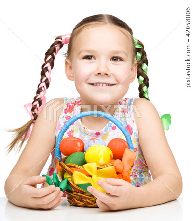 Little girl with basket full of colorful eggs 42058006