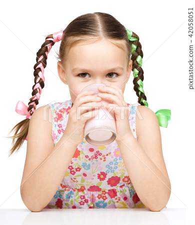 Cute little girl with a glass of milk Cute little girl with a glass of milk 42058051