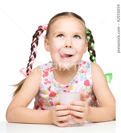 Cute little girl with a glass of milk 42058054