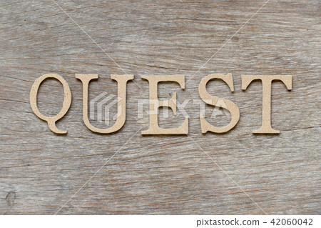 Alphabet letter in word quest on wood background Alphabet letter in word quest on wood background 42060042