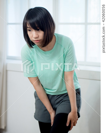 Woman checking her body Woman checking her body 42060056