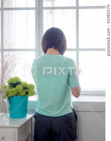 Back view of a Young girl with digital tablet in h 42060578