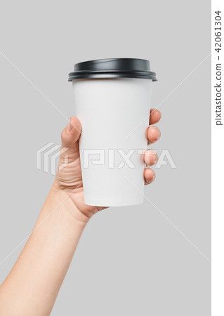 Mockup of women's hand holding white paper large size cup with black cover Mockup of women's hand holding white paper large size cup with black cover 42061304