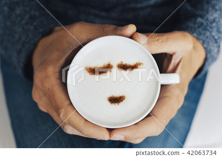 man with a cup of cappuccino man with a cup of cappuccino 42063734