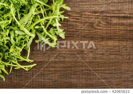 Fresh Raw Arugula (rucola) on brown wood 42065622