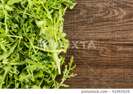 Fresh Raw Arugula (rucola) on brown wood 42065626