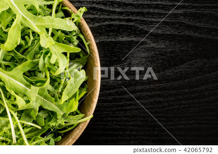 Fresh Raw Arugula (rucola) on black wood 42065792