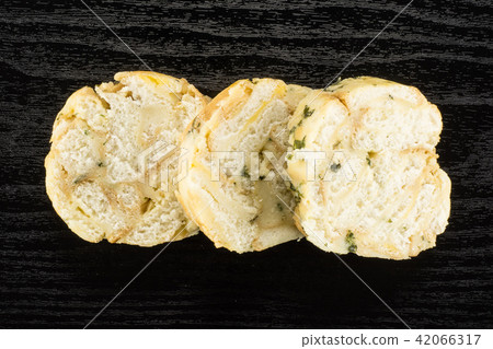 Fresh boiled Carlsbad bread dumpling on black wood Fresh boiled Carlsbad bread dumpling on black wood 42066317