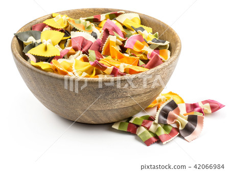Colourful raw farfalle isolated on white Colourful raw farfalle isolated on white 42066984