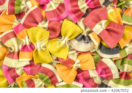Colourful raw farfalle isolated on white Colourful raw farfalle isolated on white 42067052