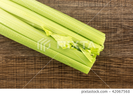 Fresh Celery isolated on brown wood Fresh Celery isolated on brown wood 42067568