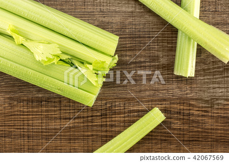 Fresh Celery isolated on brown wood Fresh Celery isolated on brown wood 42067569