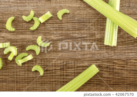 Fresh Celery isolated on brown wood Fresh Celery isolated on brown wood 42067570