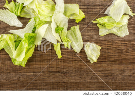 Fresh Raw Iceberg Lettuce on brown wood Fresh Raw Iceberg Lettuce on brown wood 42068040