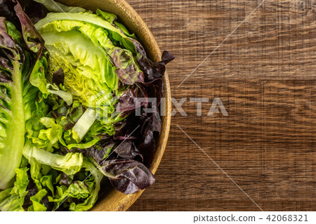 Fresh raw lettuce red little gem on brown wood Fresh raw lettuce red little gem on brown wood 42068321